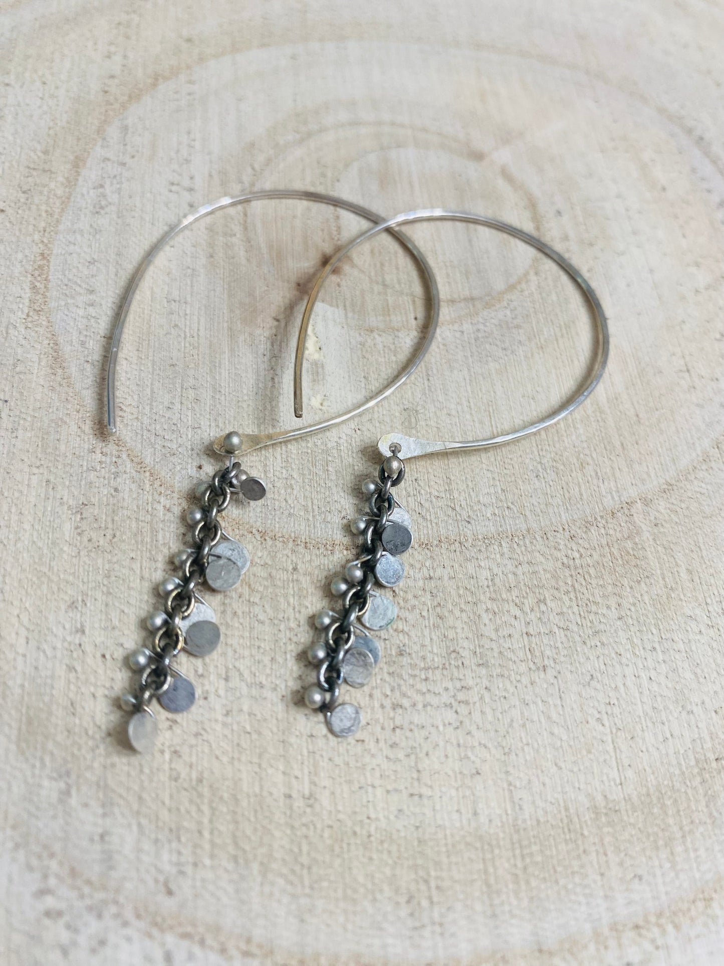 Hand forged sterling hoops with hammered silver paillettes